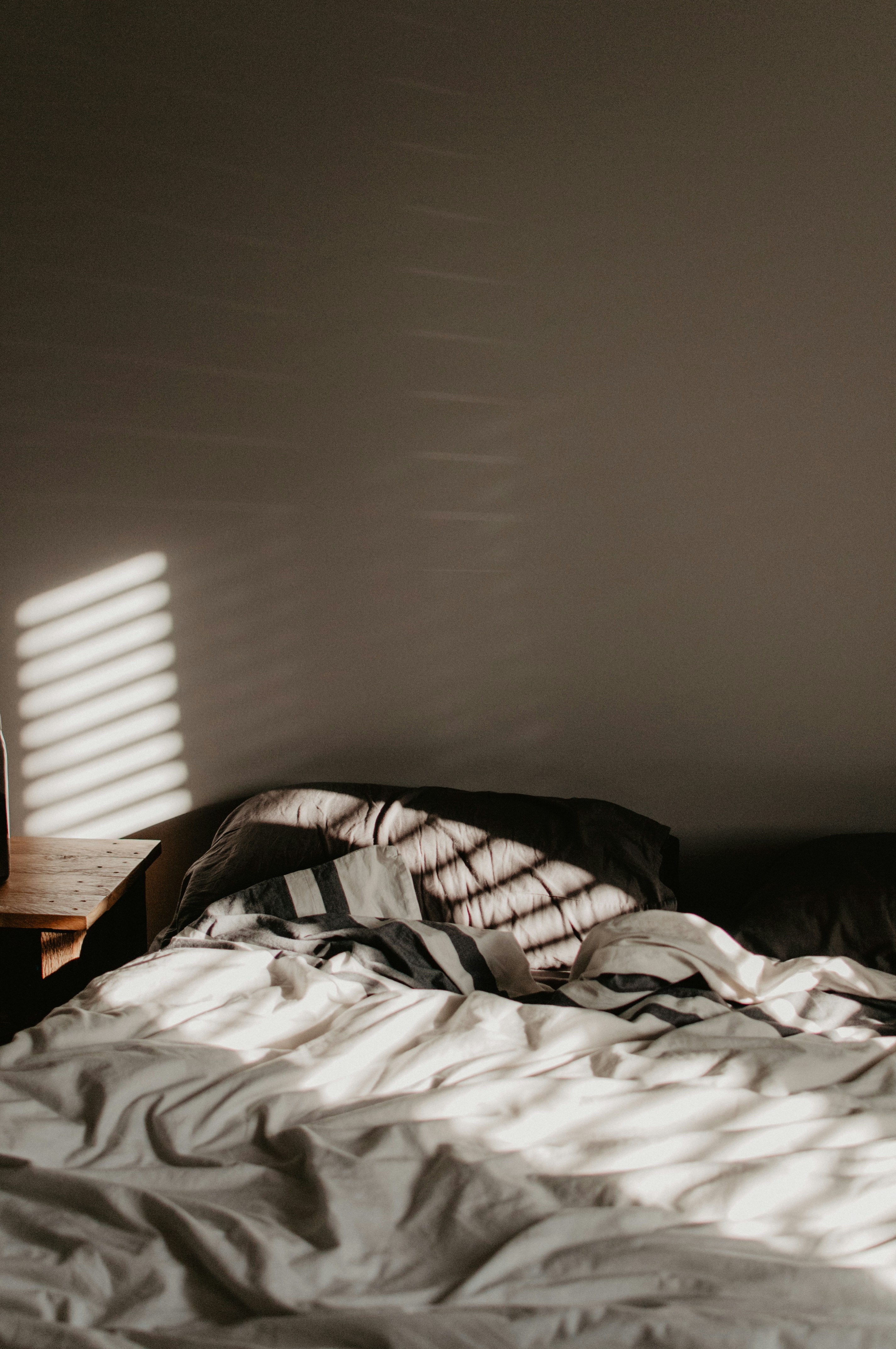 A bed with unkempt sheets